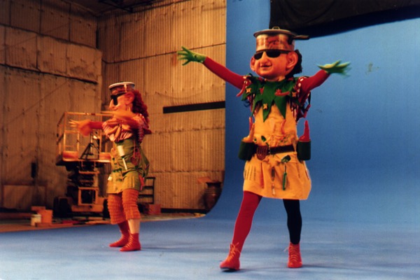 Two performers in leprechaun costumes play a scene on a blue-screen stage for Dwegons and Leprechauns.