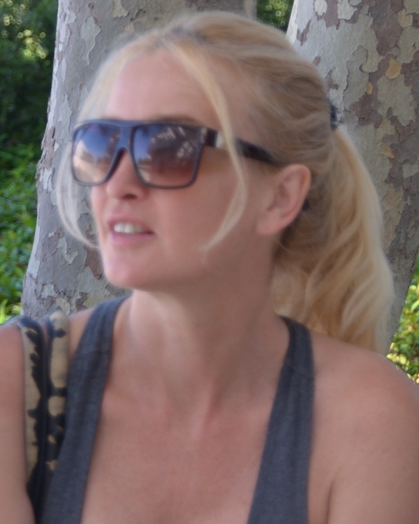 Adriana Stastny, outdoors among plane trees.