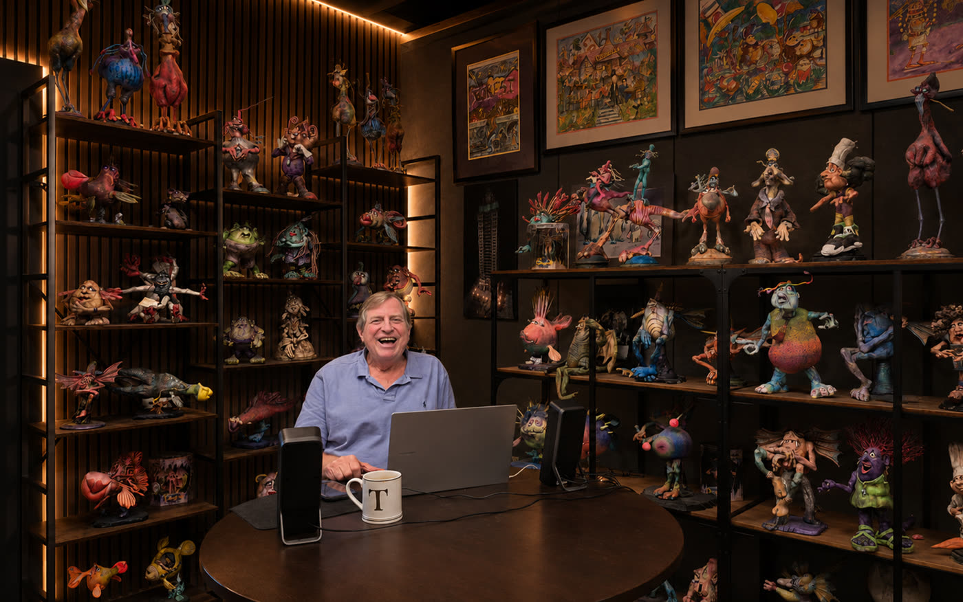 Tom Walsh at his desk in the TW3 studio, the walls behind him lined with shelves of original sculpted characters.